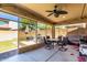 Covered patio with ceiling fan, dining table and chairs, overlooking the backyard at 1806 W Fetlock Trl, Phoenix, AZ 85085