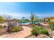 Resort-style pool offers splash pad, lounge chairs, and desert landscaping for the ultimate outdoor enjoyment at 1806 W Fetlock Trl, Phoenix, AZ 85085