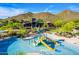 Community pool area complete with water slides and splash pads, set against a picturesque mountain backdrop at 1806 W Fetlock Trl, Phoenix, AZ 85085