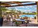 Inviting community pool area with comfortable lounge chairs, tables, and shade umbrellas for relaxing outdoor enjoyment at 1806 W Fetlock Trl, Phoenix, AZ 85085
