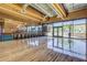 Brightly lit studio with hardwood floors, exercise bikes, and large windows overlooking the green space in Fireside at 1806 W Fetlock Trl, Phoenix, AZ 85085
