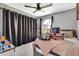 Relaxing bedroom featuring carpet, a ceiling fan, and backyard views through the window at 1914 W Onza Ave, Mesa, AZ 85202