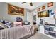 Comfortable bedroom featuring decorative artwork, ceiling fan, and television at 1914 W Onza Ave, Mesa, AZ 85202