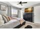 Cozy bedroom with a large window and a dark dresser with a flat screen television at 1914 W Onza Ave, Mesa, AZ 85202
