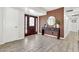 Inviting foyer with modern wood accent wall, stylish mirror and a decorative console table at 1914 W Onza Ave, Mesa, AZ 85202