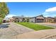 Beautiful single-Gathering home with green lawn, striking dark garage door, and decorative shrubbery at 1914 W Onza Ave, Mesa, AZ 85202
