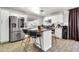 Modern kitchen with stainless steel appliances, kitchen island, and white cabinets at 1914 W Onza Ave, Mesa, AZ 85202
