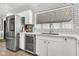 Well-lit kitchen with stainless steel refrigerator, beverage cooler, white cabinets and subway tile backsplash at 1914 W Onza Ave, Mesa, AZ 85202