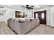 Comfortable living room with a large sectional sofa and decorative ceiling fan at 1914 W Onza Ave, Mesa, AZ 85202