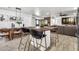 Open-concept living space featuring a kitchen island, dining area, and comfortable seating at 1914 W Onza Ave, Mesa, AZ 85202