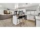 Open-concept living space featuring a kitchen island, modern appliances, and comfortable living area at 1914 W Onza Ave, Mesa, AZ 85202