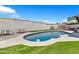 Backyard with a refreshing pool, green lawn, and picnic table at 1914 W Onza Ave, Mesa, AZ 85202
