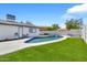 Beautiful backyard featuring a pool with grassy areas, picnic table, and landscaping at 1914 W Onza Ave, Mesa, AZ 85202