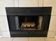 Close-up of a fireplace with logs in a tiled hearth at 2019 W Lemon Tree Pl # 1124, Chandler, AZ 85224