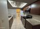 Modern kitchen with stainless steel appliances, granite countertops, and dark wood cabinets at 2019 W Lemon Tree Pl # 1124, Chandler, AZ 85224