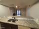 View from the kitchen, looking out to the living room with fireplace and sliding glass door at 2019 W Lemon Tree Pl # 1124, Chandler, AZ 85224