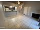 Bright living room with tiled floors, fireplace, and access to the kitchen at 2019 W Lemon Tree Pl # 1124, Chandler, AZ 85224