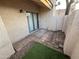 Enclosed patio space with sliding glass doors, hardscape, and decorative gravel accents at 2019 W Lemon Tree Pl # 1124, Chandler, AZ 85224