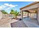 View from the patio to the pool area, surrounded by desert landscaping, palm trees, and shade at 21054 N Sansom Dr, Maricopa, AZ 85138