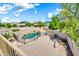 Aerial view of the backyard featuring brick pavers, a pool, desert landscaping, and block wall at 21054 N Sansom Dr, Maricopa, AZ 85138