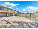 Spacious brick-paved backyard with an iron fence surrounding the pool and house, with a covered patio at 21054 N Sansom Dr, Maricopa, AZ 85138