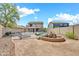 Backyard with pool, rock features, and wrought-iron fence at 21054 N Sansom Dr, Maricopa, AZ 85138