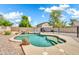 Beautiful backyard featuring a pool, rock accents, and well-maintained landscaping at 21054 N Sansom Dr, Maricopa, AZ 85138