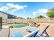 Inviting backyard featuring a pool, lounge chairs, and rock accents at 21054 N Sansom Dr, Maricopa, AZ 85138