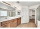 Bathroom boasts dual sinks, a walk-in shower, and walk-in closet at 21054 N Sansom Dr, Maricopa, AZ 85138
