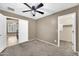 Bedroom with carpet flooring, neutral walls, ceiling fan, and a closet at 21054 N Sansom Dr, Maricopa, AZ 85138