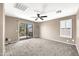 Bright bedroom with a sliding glass door leading to the exterior and shutters on the window at 21054 N Sansom Dr, Maricopa, AZ 85138