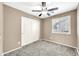 Bedroom features carpeting, a ceiling fan and a window with shutters at 21054 N Sansom Dr, Maricopa, AZ 85138