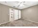 Neutral bedroom featuring a fan, carpet flooring, and two closets at 21054 N Sansom Dr, Maricopa, AZ 85138