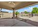 Covered patio overlooks the pool with desert landscaping, pavers, and a block wall at 21054 N Sansom Dr, Maricopa, AZ 85138