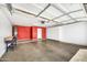 Spacious garage with red accent wall and storage cabinets at 21054 N Sansom Dr, Maricopa, AZ 85138