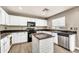 Efficient kitchen space with stainless steel appliances, island, and a view of the yard at 21054 N Sansom Dr, Maricopa, AZ 85138