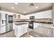 Updated kitchen with white cabinets, granite countertops, stainless steel appliances at 21054 N Sansom Dr, Maricopa, AZ 85138