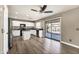 Open kitchen with stainless steel refrigerator, white cabinets, and access to the patio at 21054 N Sansom Dr, Maricopa, AZ 85138