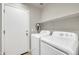 Convenient laundry room with modern appliances and ample shelving at 21054 N Sansom Dr, Maricopa, AZ 85138