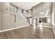 Open-concept living room boasting a staircase, high ceilings, wood-style floors, and a view into other rooms at 21054 N Sansom Dr, Maricopa, AZ 85138