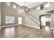 Open living space featuring a staircase, high ceilings, wood-style floors, and neutral paint at 21054 N Sansom Dr, Maricopa, AZ 85138