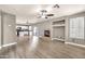 Living space with a fireplace, wood-style floors, and a view into the kitchen and sliding glass doors at 21054 N Sansom Dr, Maricopa, AZ 85138