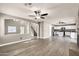 Open living space featuring wood-style floors, neutral walls, and a view into the kitchen area of the home at 21054 N Sansom Dr, Maricopa, AZ 85138