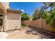 This backyard is landscaped with rock, artificial grass, palm trees, and a fire pit at 21059 E Pickett St, Queen Creek, AZ 85142