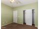 This bedroom is equipped with carpet, closet with sliding doors, and a neutral wall color at 21059 E Pickett St, Queen Creek, AZ 85142
