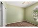 This bedroom features neutral walls, brown carpet, a ceiling fan, and a window providing natural light at 21059 E Pickett St, Queen Creek, AZ 85142