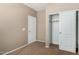 This bedroom features neutral walls, carpeted floors, closet with sliding doors, and white trim at 21059 E Pickett St, Queen Creek, AZ 85142