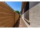 A narrow rock-covered passage runs along the side of the house, with a wall on one side at 21059 E Pickett St, Queen Creek, AZ 85142