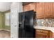 Close-up of a kitchen with wood cabinets, black fridge, and modern tile backsplash at 21059 E Pickett St, Queen Creek, AZ 85142