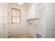 The laundry room has tile floors, a window, built-in cabinets, and a utility sink at 21059 E Pickett St, Queen Creek, AZ 85142